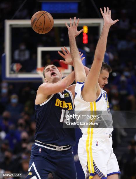 Nikola Jokic of the Denver Nuggets is fouled by Nemanja Bjelica of the Golden State Warriors at Chase Center on October 06, 2021 in San Francisco,...