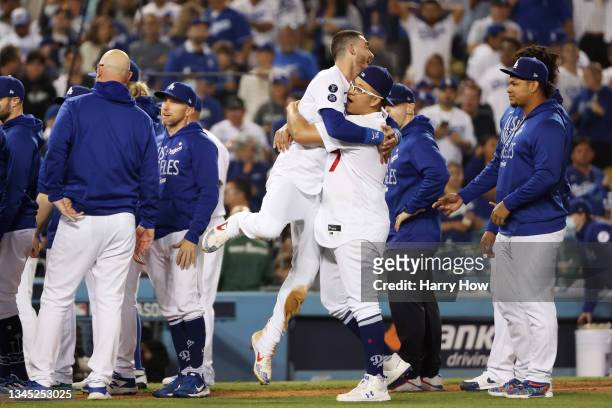 Cody Bellinger and Julio Urias of the Los Angeles Dodgers celebrate their 3 to 1 win over the St. Louis Cardinals during the National League Wild...