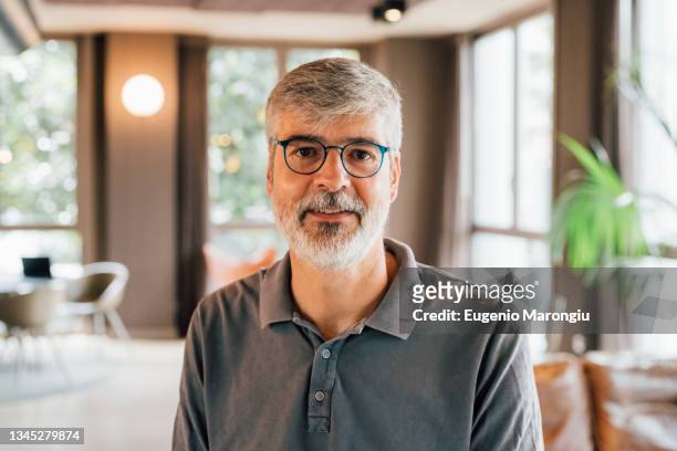 italy, portrait of businessman in creative studio - grey polo shirt stock pictures, royalty-free photos & images