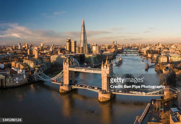 uk, london, aerial view of tower bridge over river thames at sunset - tower bridge imagens e fotografias de stock