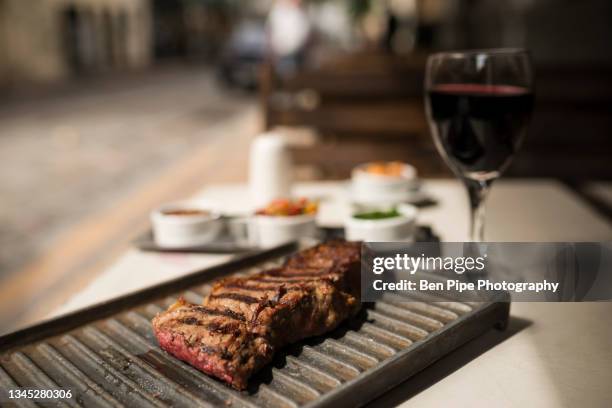 argentina, buenos aires, steak meal at traditional parrillia - argentina wine stock pictures, royalty-free photos & images