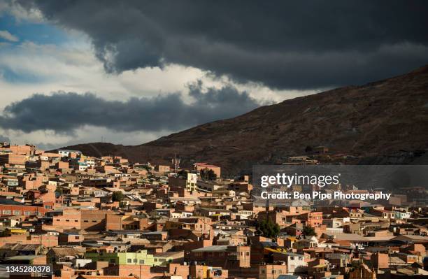 bolivia, potosi, aerial view of city buildings and hill under storm clouds - potosi stock pictures, royalty-free photos & images