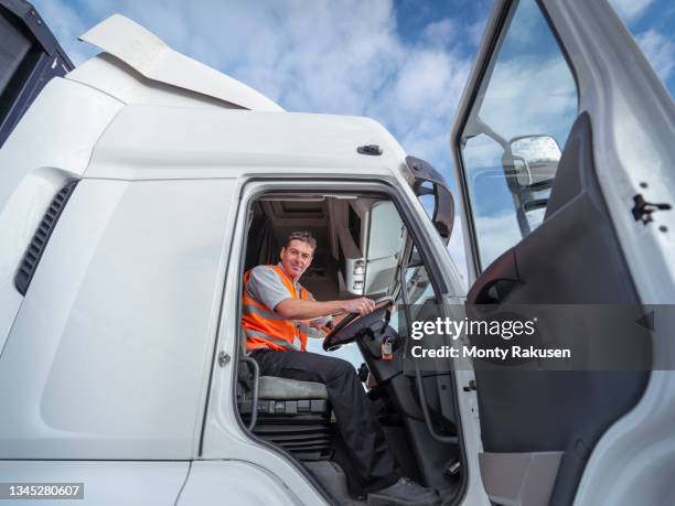 uk, portrait of smiling truck driver - lorry driver stock pictures, royalty-free photos & images
