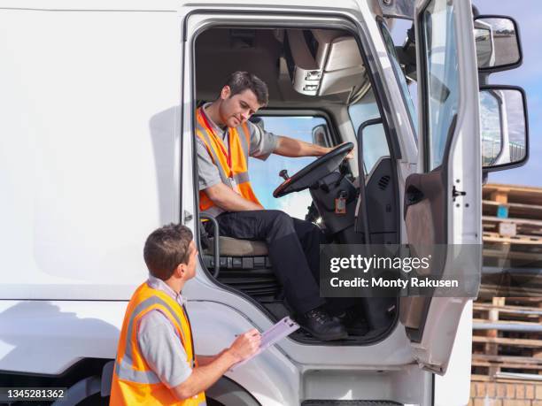 uk, truck driver and supervisor checking paperwork - lorry uk photos et images de collection