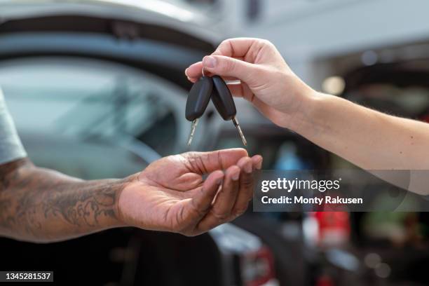 uk, close-up of hands with car keys - handing over keys stock pictures, royalty-free photos & images