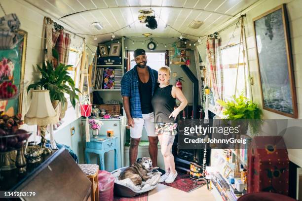 londoners and dog enjoying cozy lifestyle on canal boat - house boat stock pictures, royalty-free photos & images