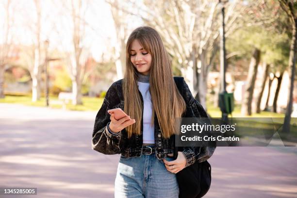 teenager student girl using smartphone outdoors - college girl stock pictures, royalty-free photos & images