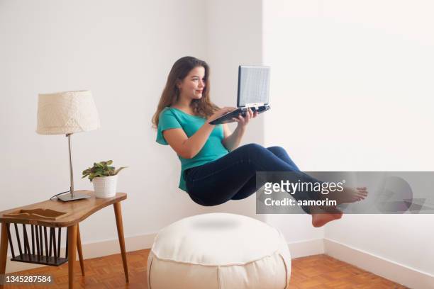 woman floating in air with laptop - people in air stock pictures, royalty-free photos & images
