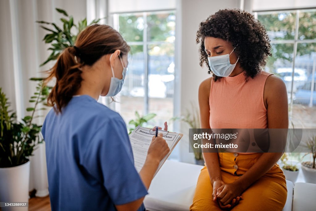 Doctor having a consultation with a patient about the Covid-19 vaccine