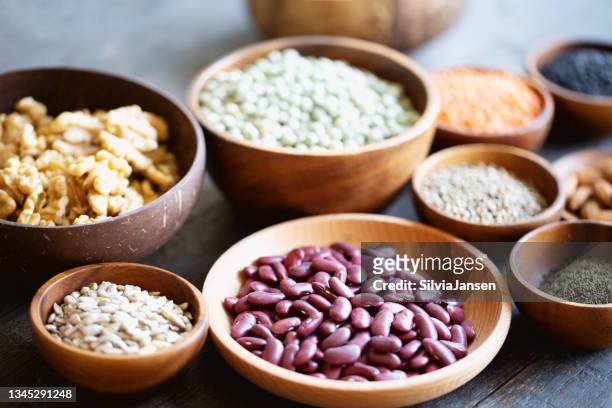 vegan food: plant based proteins like nuts, seeds and  legumes - bean stock pictures, royalty-free photos & images