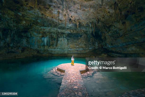 woman alone in a cenote, mexico - inner views stock-fotos und bilder