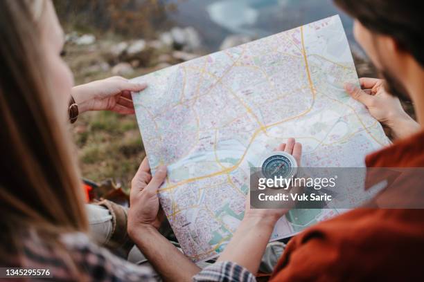 campers using compass and a map - navigational compass stockfoto's en -beelden