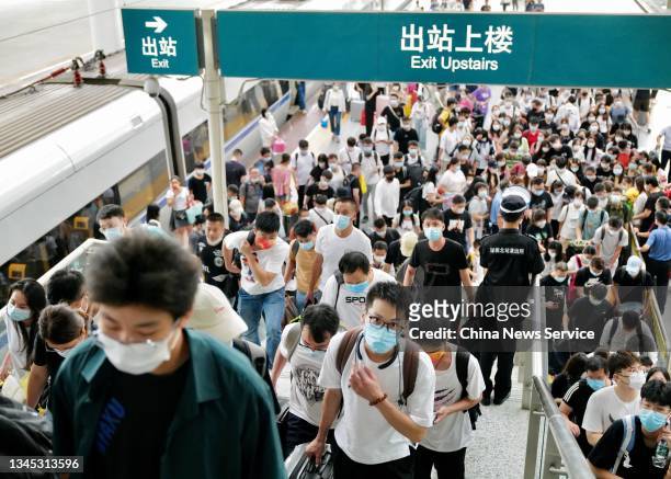 Passengers prepare to leave Shenzhen North Railway Station on the last day of Chinese National Day holiday on October 7, 2021 in Shenzhen, Guangdong...