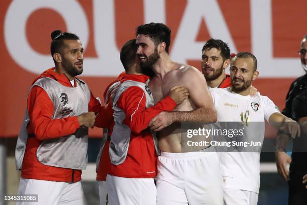 Omar Khrbin of Syria celebrates with team-mates after scoring the team's first goal during the FIFA World Cup Asian Qualifier Final Round Group A...