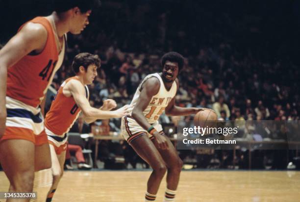 Basketball player Earl Monroe of the New York Knicks tries to dribble around Mike Riordan of the Baltimore Bullets during a Madison Square Garden...