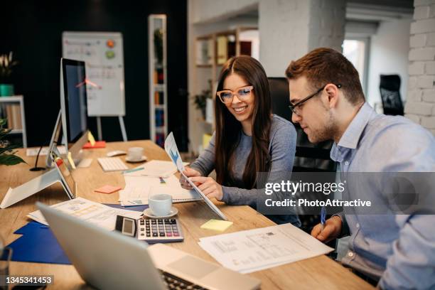 two young businessman having a successful meeting in modern office. - new colleague stock pictures, royalty-free photos & images