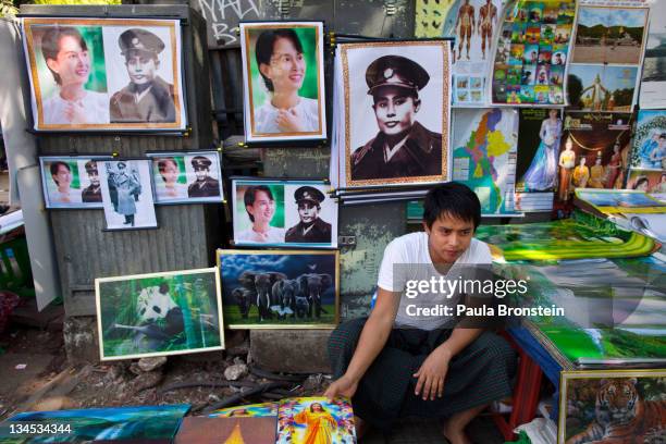 Posters of human rights activist and politician Aung San Suu Kyi and her father Aung San are sold by a street vendor on December 2, 2011 in Yangon,...
