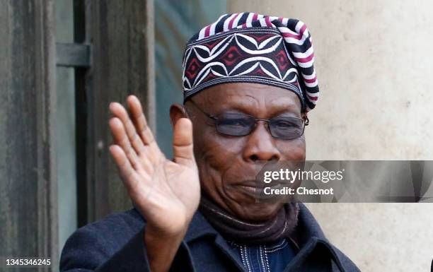 High representative of the African union for the horn of Africa and former Nigerian President Olusegun Obasanjo waves as he arrives for a meeting...