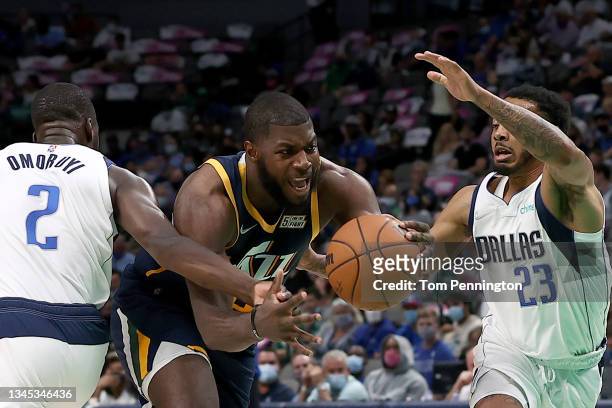 Eric Paschall of the Utah Jazz drives to the basket against Eugene Omoruyi of the Dallas Mavericks and Carlik Jones of the Dallas Mavericks in the...