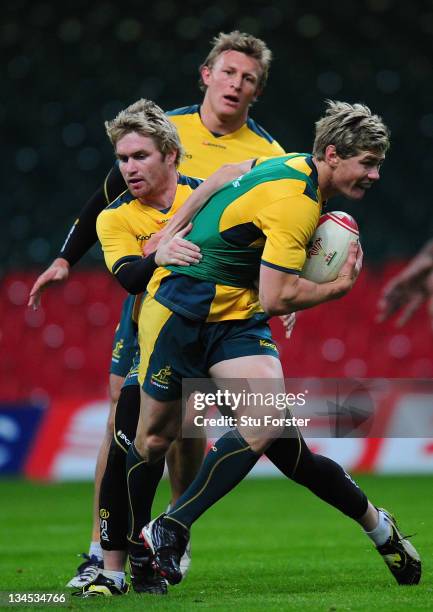 Australia centre Berrick Barnes is tackled by Ben Lucas during the Wallabies Captain's Run ahead of tomorrows international game against Wales at the...