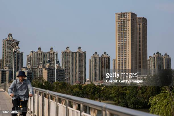 Resident cycles through the Evergrande city during the last day of the National Day and Golden Week holidays on October 7, 2021 in Wuhan, Hubei...