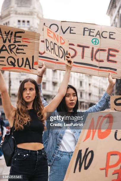 anti-racism protest in the city street. a group of students marching together - anti asian racism bildbanksfoton och bilder