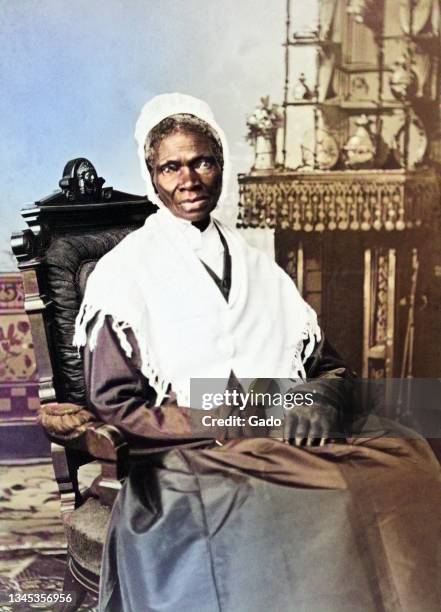 Three quarter length portrait of civil rights activist Sojourner Truth wearing a shawl and seated in a chair, 1870. Note: Image has been digitally...