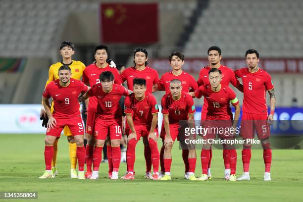 Players of China PR pose ahead of the FIFA World Cup Asian Qualifier final round Group B match between China and Vietnam at Sharjah Stadium on...