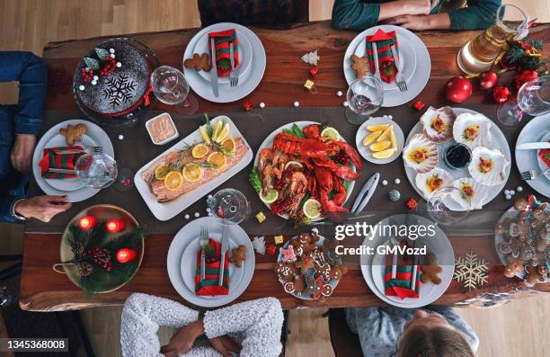 christmas dinner with salmon fish fillet, scallops, lobster, shrimps and christmas cake - december 6 stock pictures, royalty-free photos & images