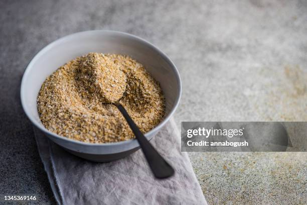 overhead view of a bowl of milled oatmeal bran on a folded napkin - bran stock pictures, royalty-free photos & images