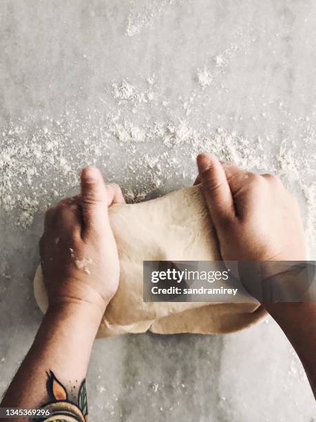 overhead view of a woman making sourdough pizza dough - sourdough bread stock pictures, royalty-free photos & images