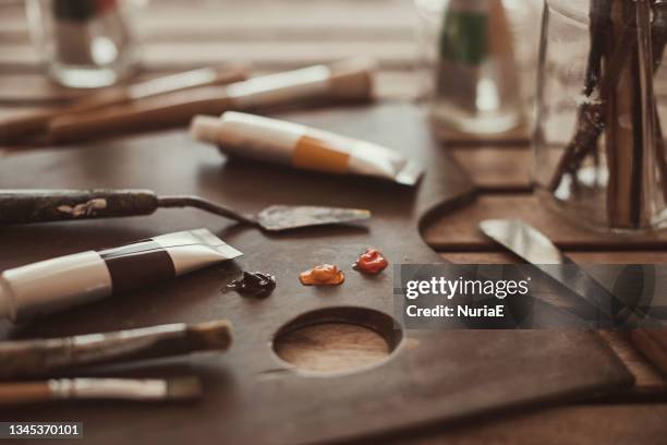 oil paint, paintbrushes and painting materials on a palette - paint tube stock pictures, royalty-free photos & images