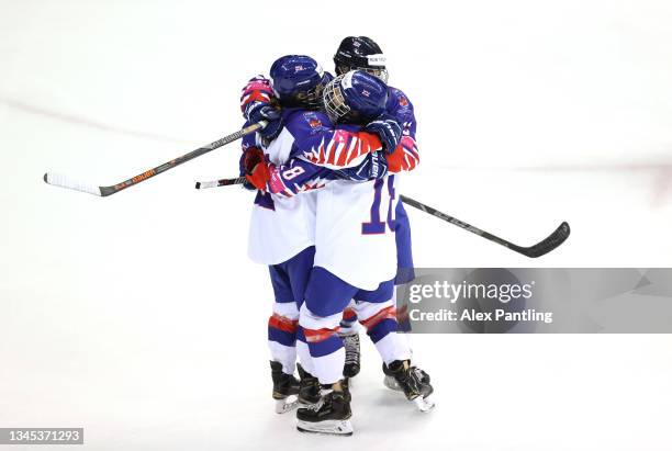 Katherine Gale of Team Great Britain celebrates with team mates after scoring her sides first goal during the Women's Ice Hockey - Beijing 2022...