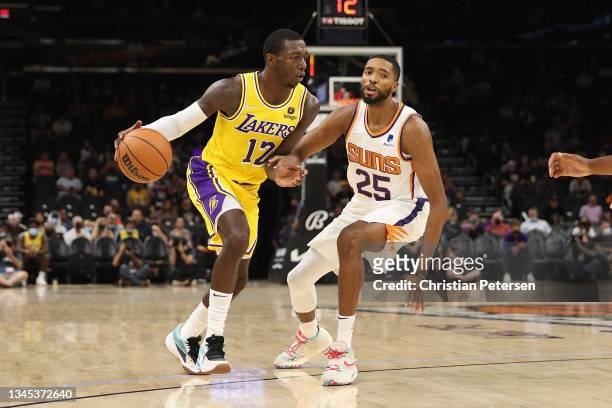 Kendrick Nunn of the Los Angeles Lakers handles the ball against Mikal Bridges of the Phoenix Suns during the NBA preseason game at Footprint Center...