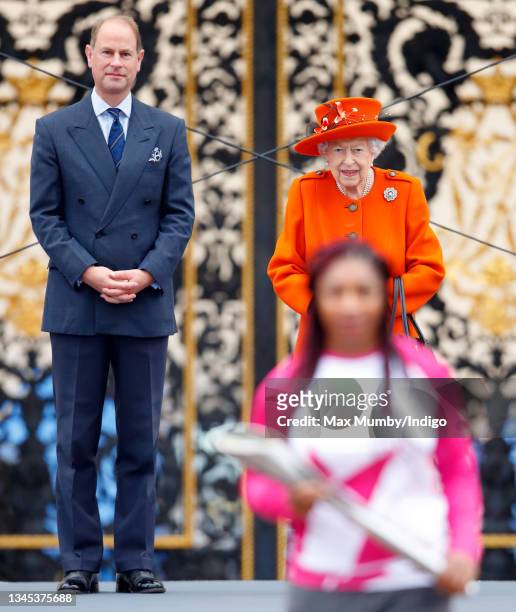 Prince Edward, Earl of Wessex and Queen Elizabeth II look on as Kadeena Cox carries The Queen's Baton during the launch of the Queen's Baton Relay...
