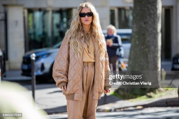 Emili Sindlev seen wearing beige pants, puffer jacket outside Miu Miu during Paris Fashion Week - Womenswear Spring Summer 2022 on October 05, 2021...