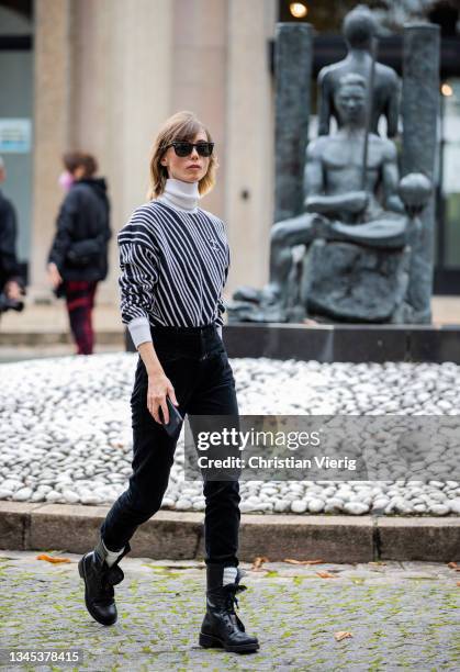Anya Ziourova seen wearing Chanel jumper, black pants outside Miu Miu during Paris Fashion Week - Womenswear Spring Summer 2022 on October 05, 2021...