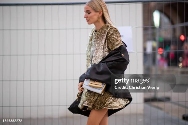 Leonie Hanne seen wearing golden dress, jacket, white golden bag outside Louis Vuitton during Paris Fashion Week - Womenswear Spring Summer 2022 on...