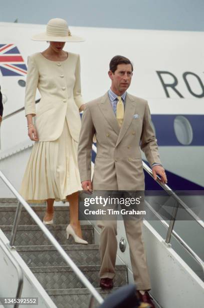 British Royals Diana, Princess of Wales , wearing a Catherine Walker suit with a Philip Somerville hat, and Charles, Prince of Wales, disembarking on...
