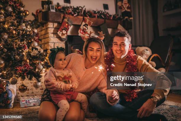 happy family celebrating christmas and new year holidays at home - happy holidays family stock pictures, royalty-free photos & images