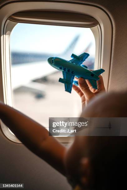 child flying in the airplane. playing with a airplane toy. - modellflygplan bildbanksfoton och bilder