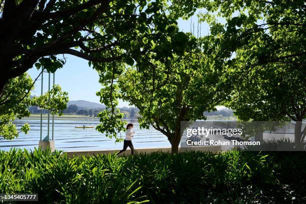 Exercisers by Lake Burley Griffin on October 08, 2021 in Canberra, Australia. Lockdown restrictions remain in place for Canberra, with residents...