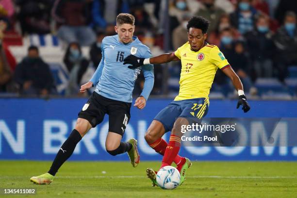 Johan Mojica of Colombia fights for the ball with Federico Valverde of Uruguay during a match between Uruguay and Colombia as part of South American...