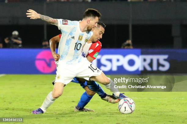 Lionel Messi of Argentina and Angel Cardozo Lucena of Paraguay fight for the ball during a match between Paraguay and Argentina as part of South...