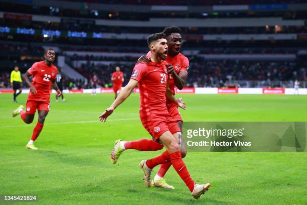 Jonathan Osorio of Canada celebrates with teammates after scoring the first goal of his team during the match between Mexico and Canada as part of...