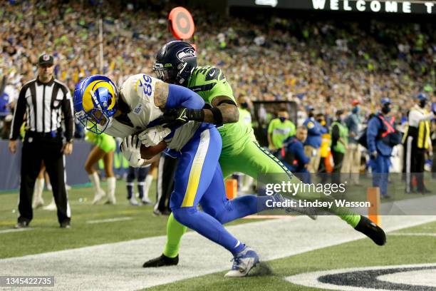 Tight end Tyler Higbee of the Los Angeles Rams catches a second half touchdown pass in front of safety Jamal Adams of the Seattle Seahawks at Lumen...