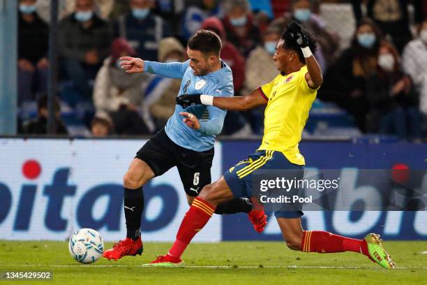 Nahitan Nandez of Uruguay fights for the ball with Johan Mojica of Colombia during a match between Uruguay and Colombia as part of South American...