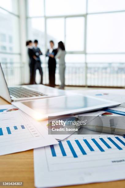 business team discussing chart in the office - formal businesswear stock pictures, royalty-free photos & images