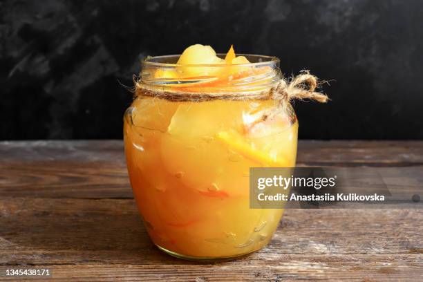 apple jam with orange zest. jar of jam. wooden background. - marmellata foto e immagini stock
