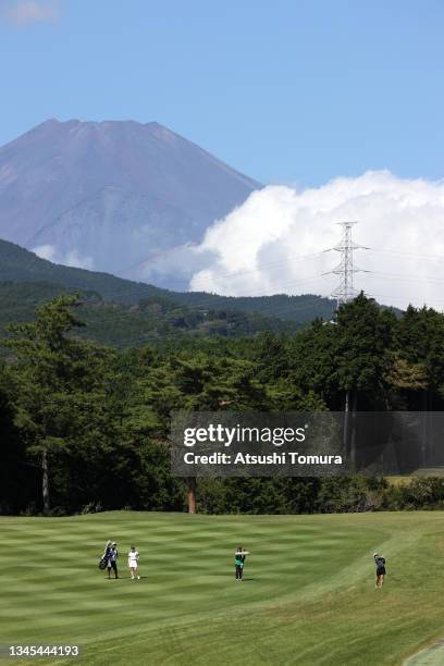 Mone Inami of Japan hits her second shot on the 5th hole while Mt. Fuji is seen on the back during the first round of the Stanley Ladies at Tomei...